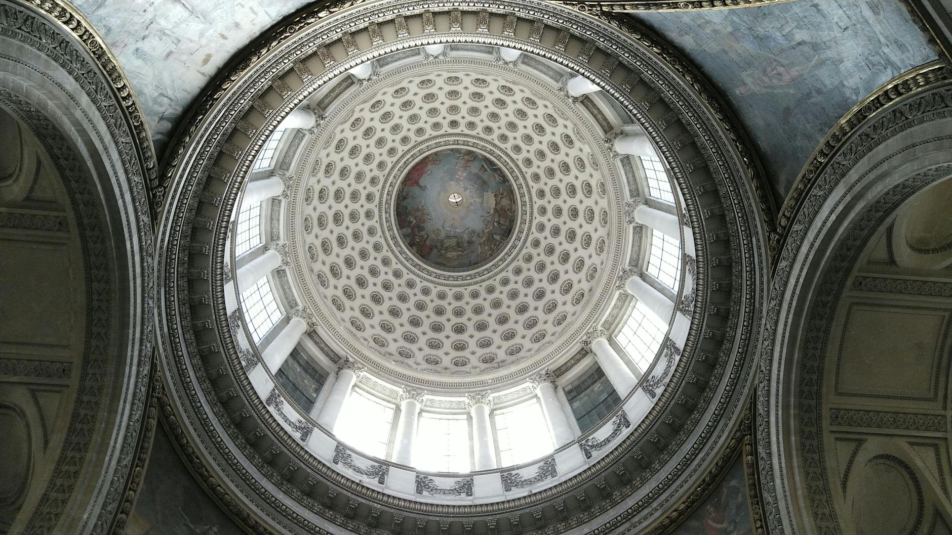 A stunning view of a grand architectural dome featuring intricate detailing and grand pillars.