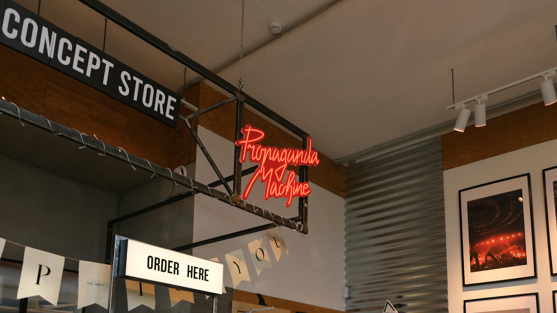 Interior of a modern concept store featuring neon signage and contemporary decor.