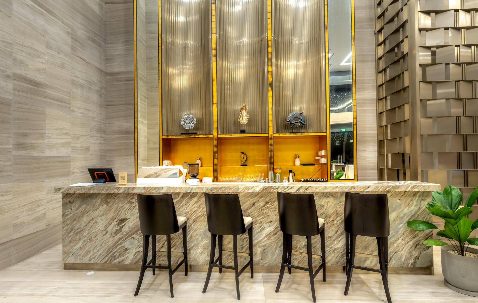 A luxurious and modern bar counter with stylish stools in a hotel's elegant interior design.
