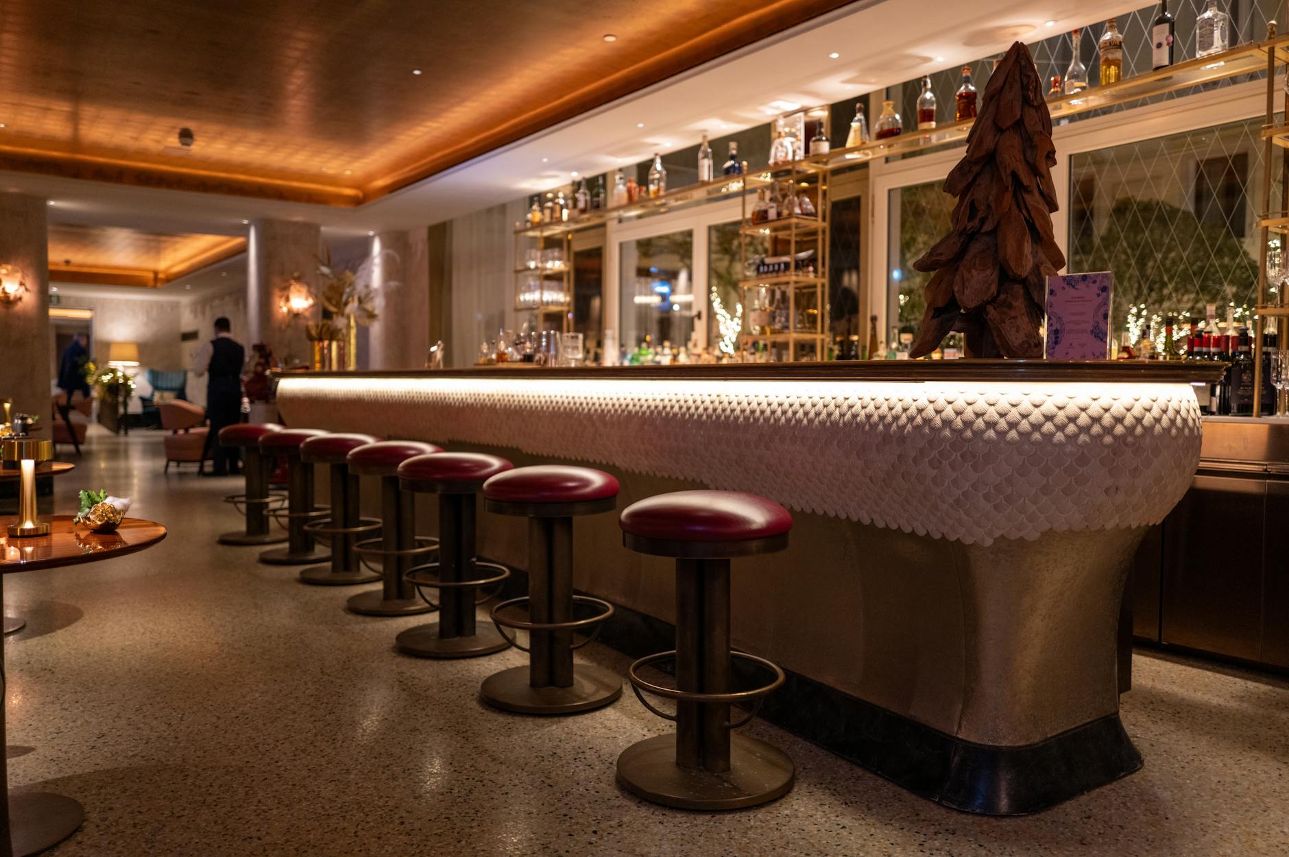 Explore the luxurious ambiance of a hotel bar with elegant seating and sophisticated decor.