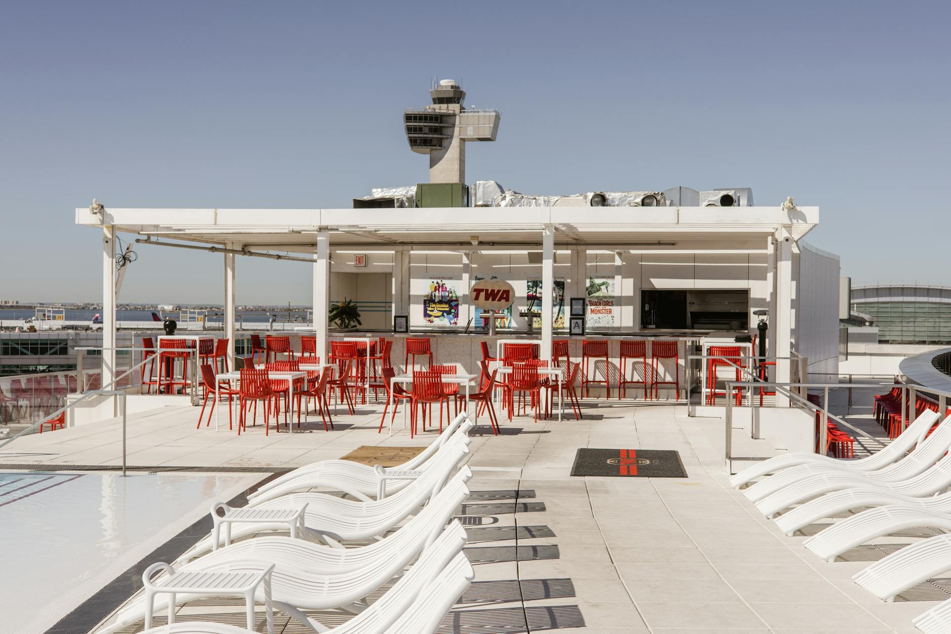 Discover the sunlit luxury rooftop bar at TWA Hotel, offering stunning views and modern amenities in New York City.