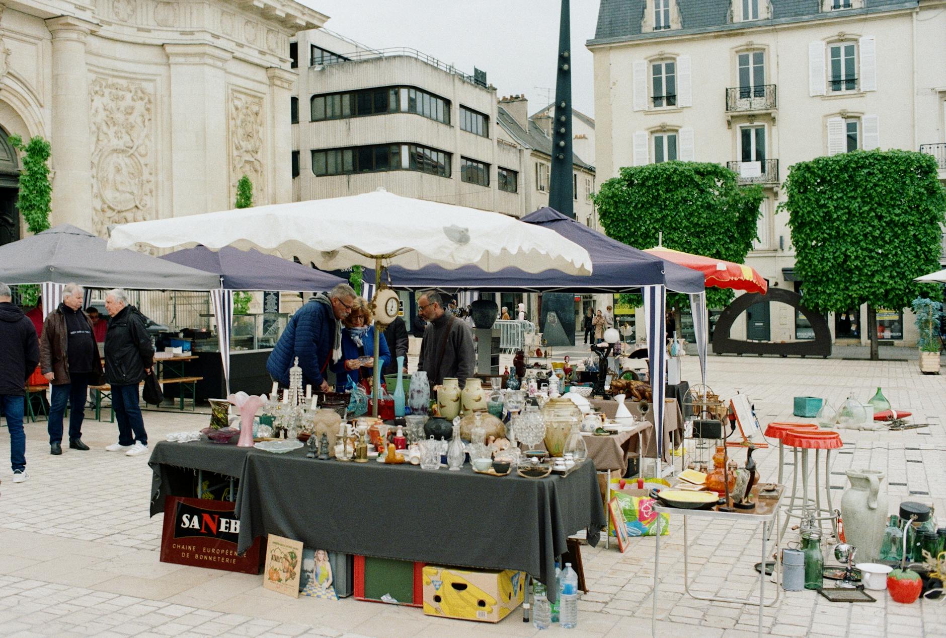 Explore vibrant market stalls in Nancy's town square, Grand Est, France.