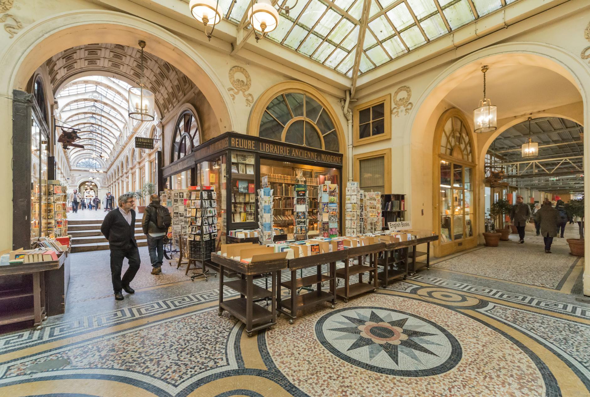 A picturesque Parisian shopping arcade showcasing vintage bookstores and mosaic floors.