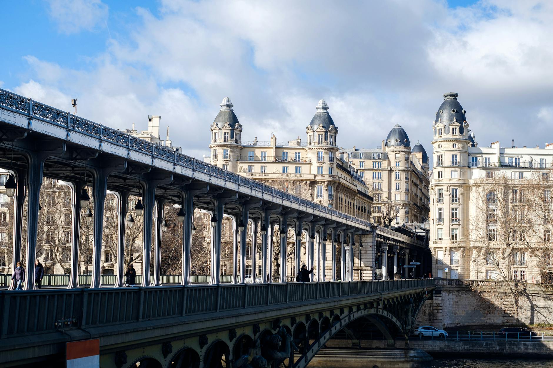 The iconic Pont de Bir-Hakeim with classic Haussmann architecture in Paris on a clear day.