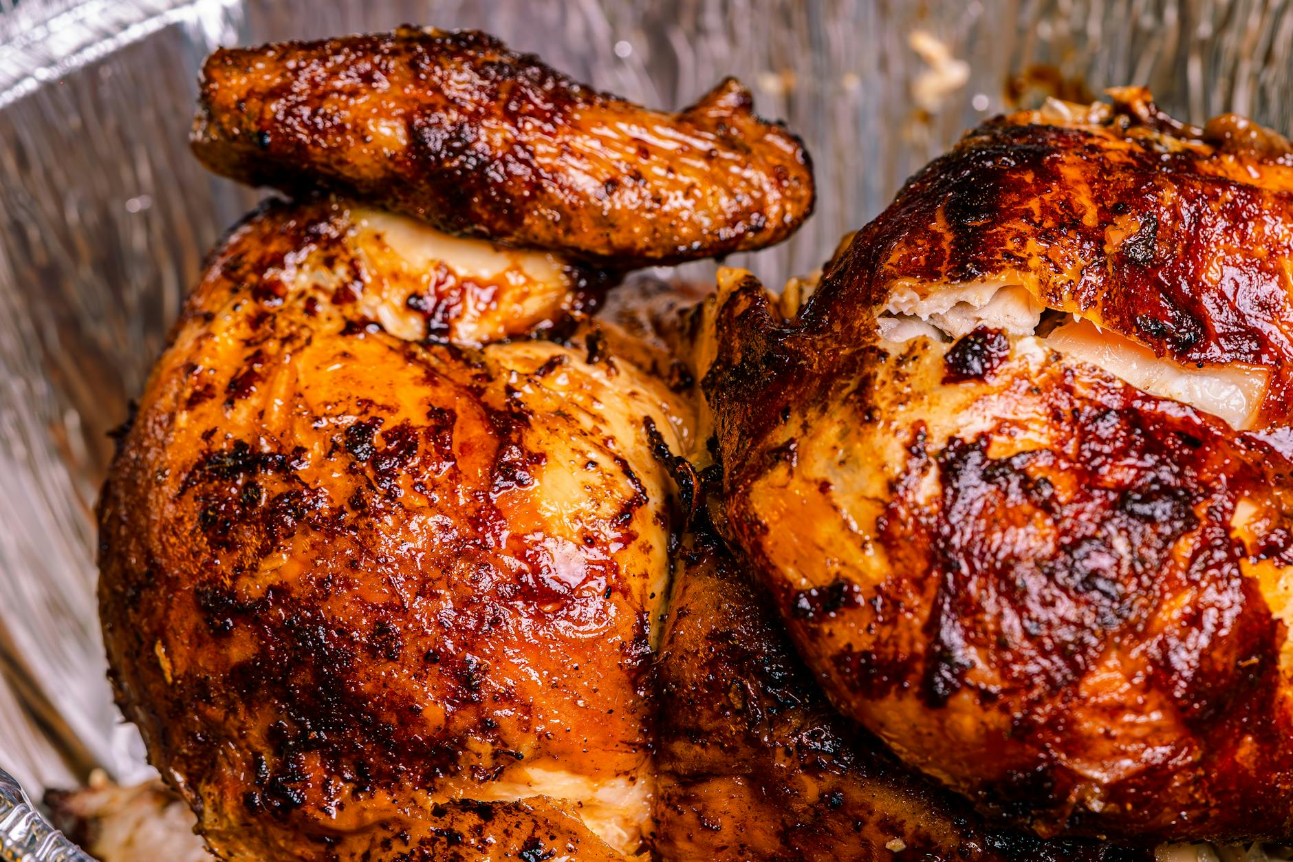 Deliciously roasted rotisserie chicken with crispy skin, perfect for a hearty meal.