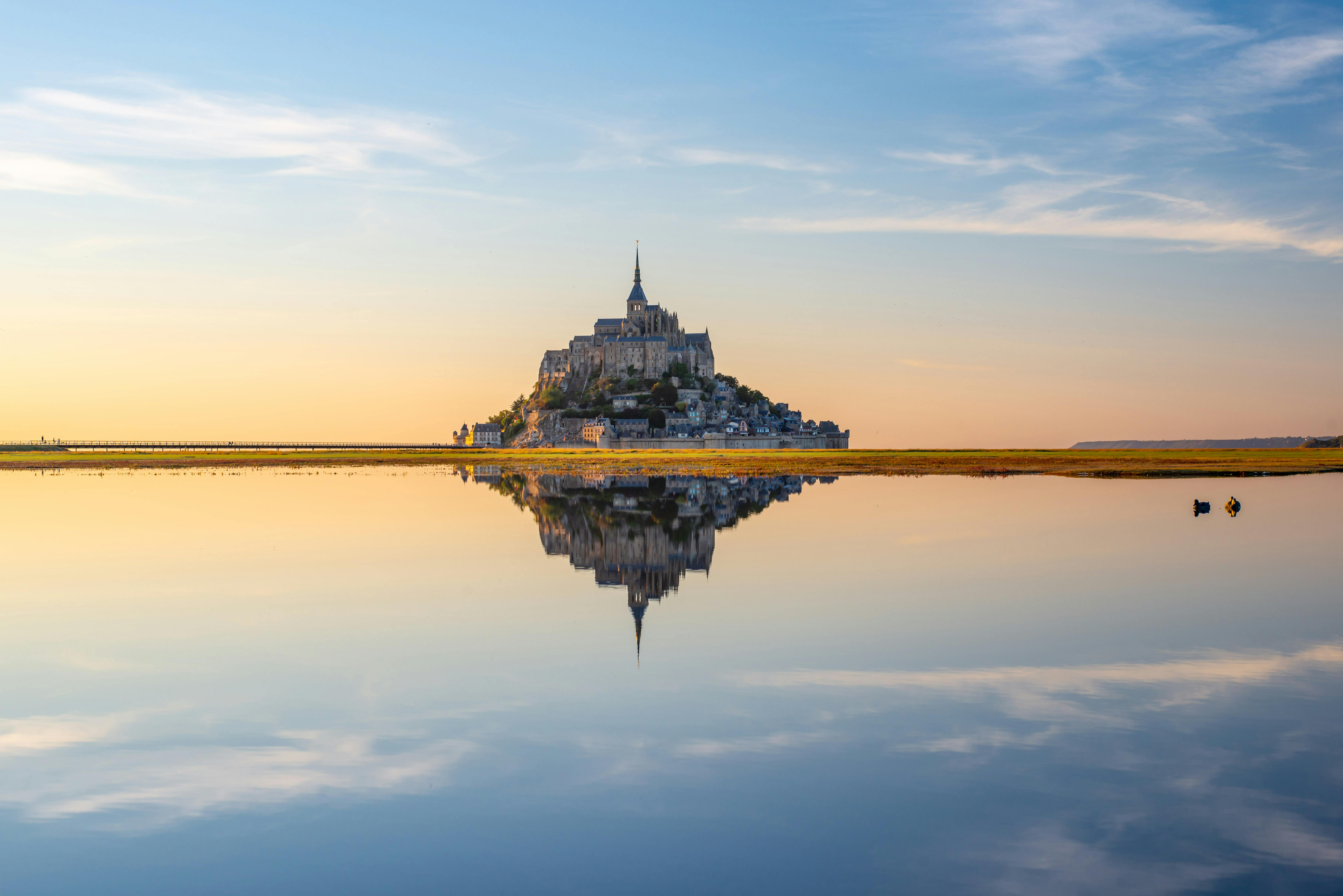 Mont Saint-Michel abbey at golden sunset in Normandy, France