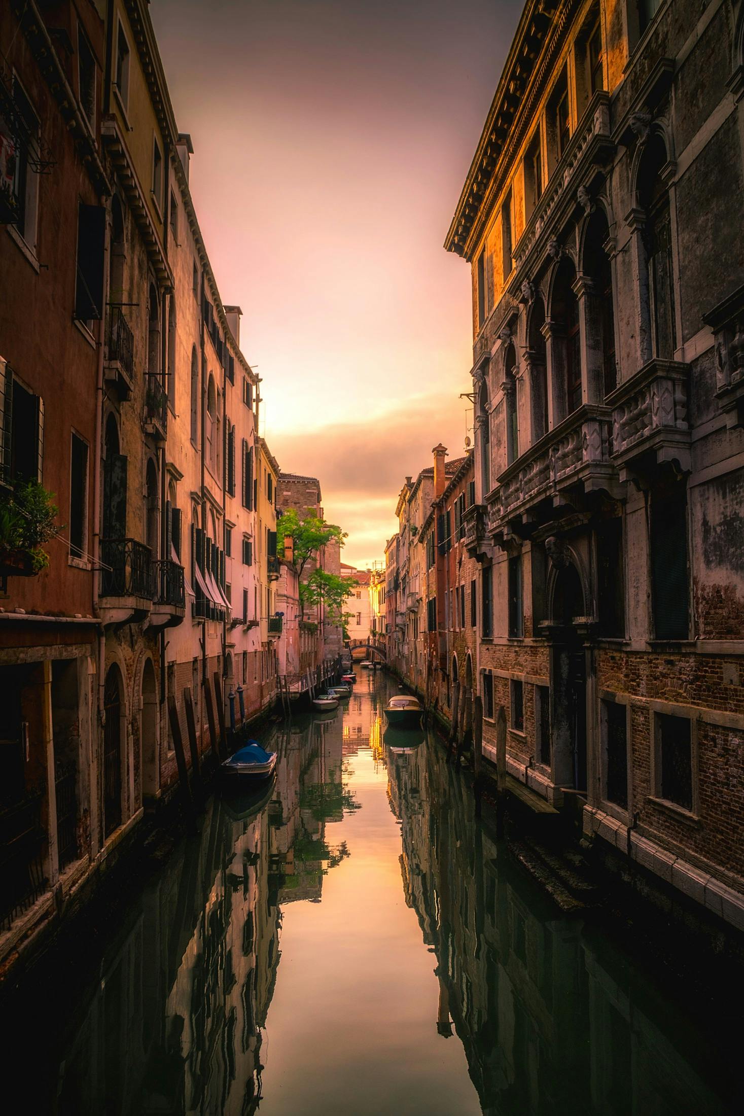 Serene view of Venice canal with gondola at golden sunset, Venice, Italy - Venice tours