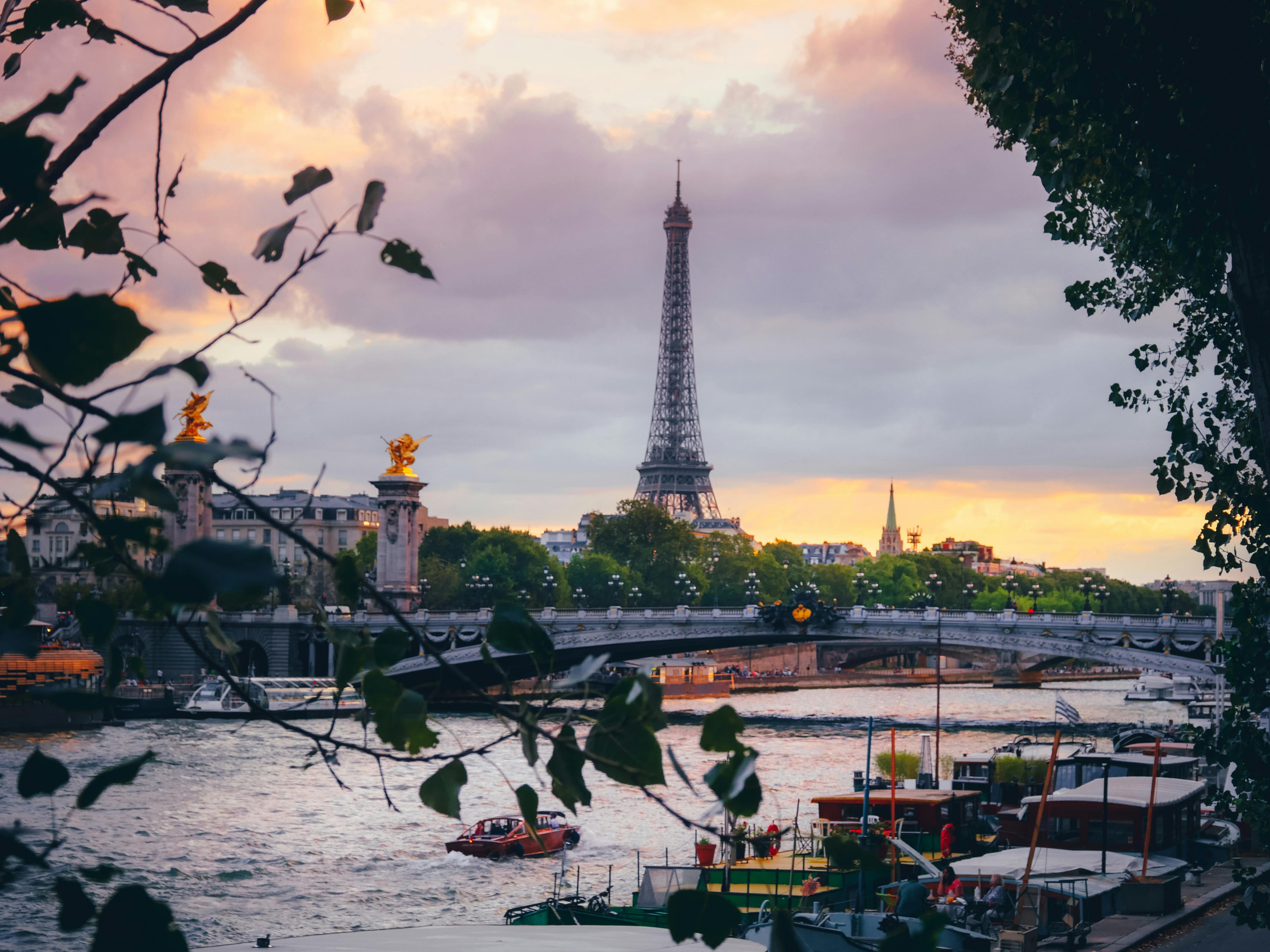 Romantic sunset view of the Eiffel Tower and Seine River in Paris, France - Chic Trip travel planning