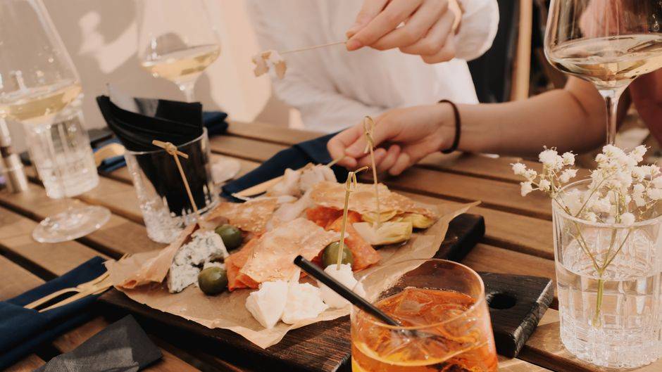 Wine and charcuterie shared at a table