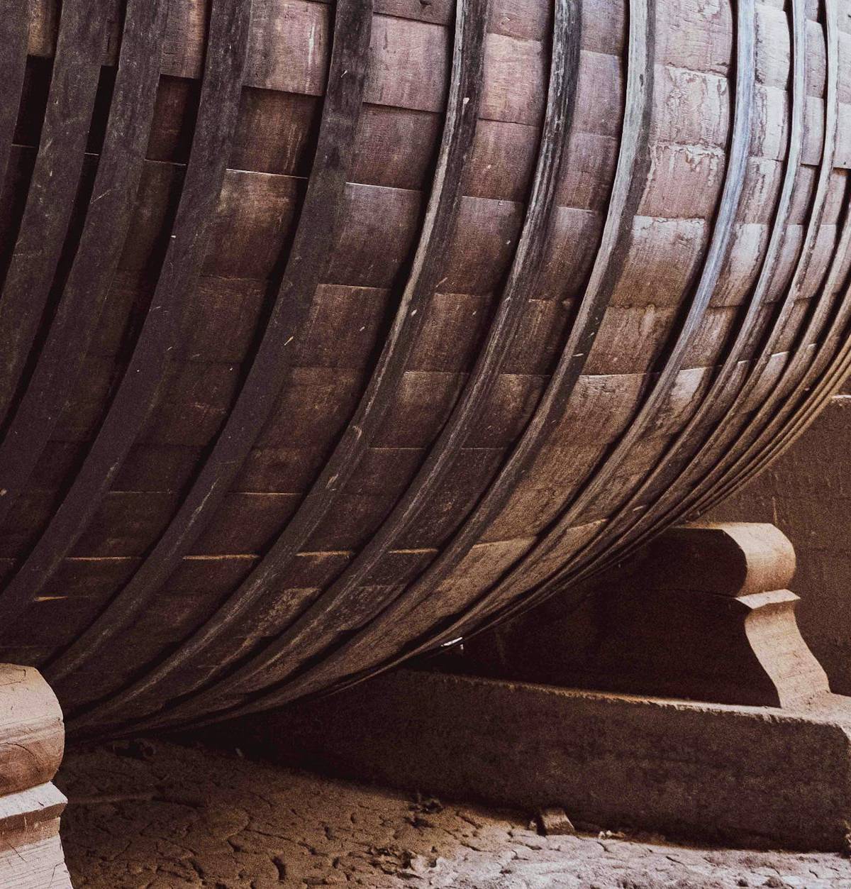 An oak wine barrel in a cellar, illustrative photograph