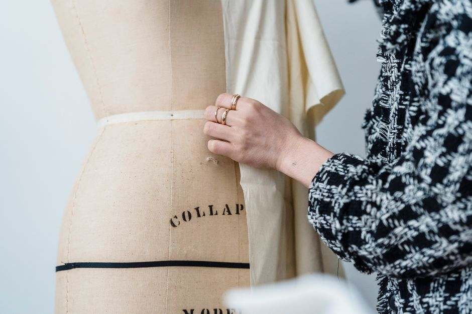 A garment being fitted on a dress form, illustrative atelier photograph