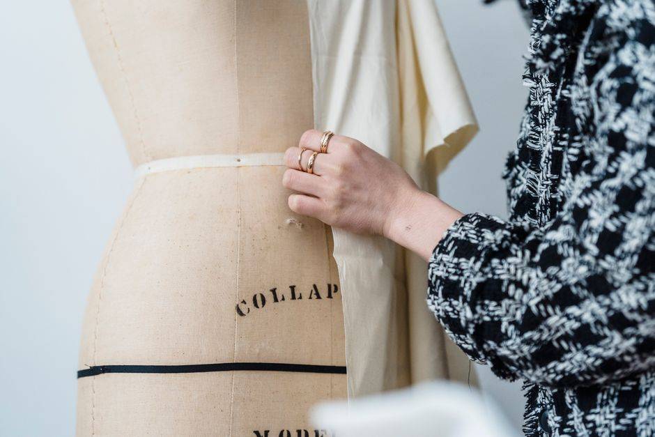 A garment being fitted on a dress form, illustrative atelier photograph