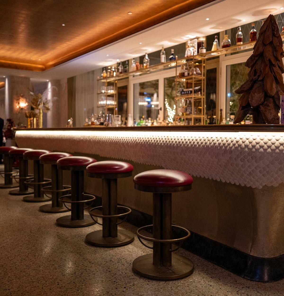 A warmly lit cocktail bar, illustrative photograph