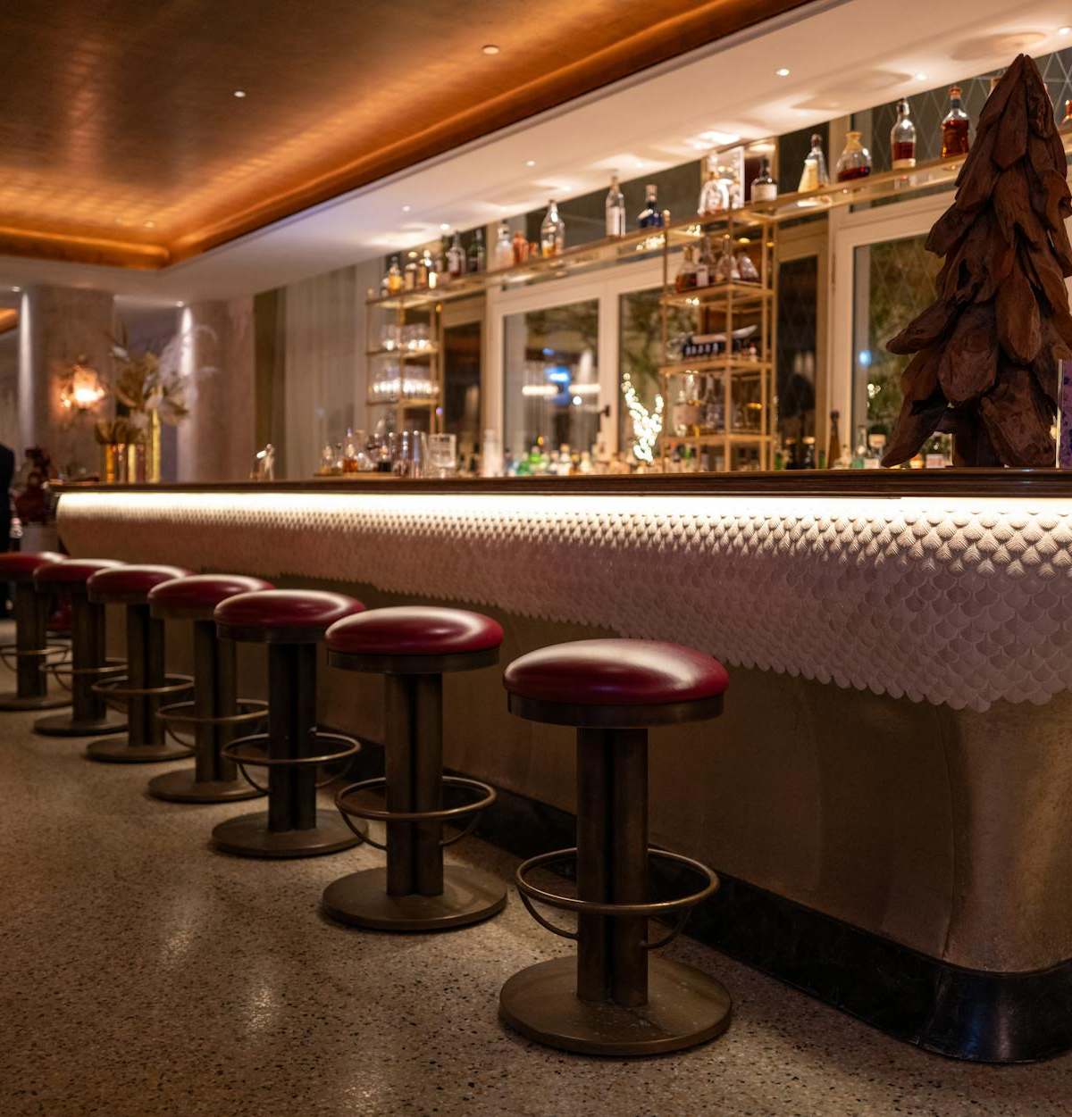 Explore the luxurious ambiance of a hotel bar with elegant seating and sophisticated decor.