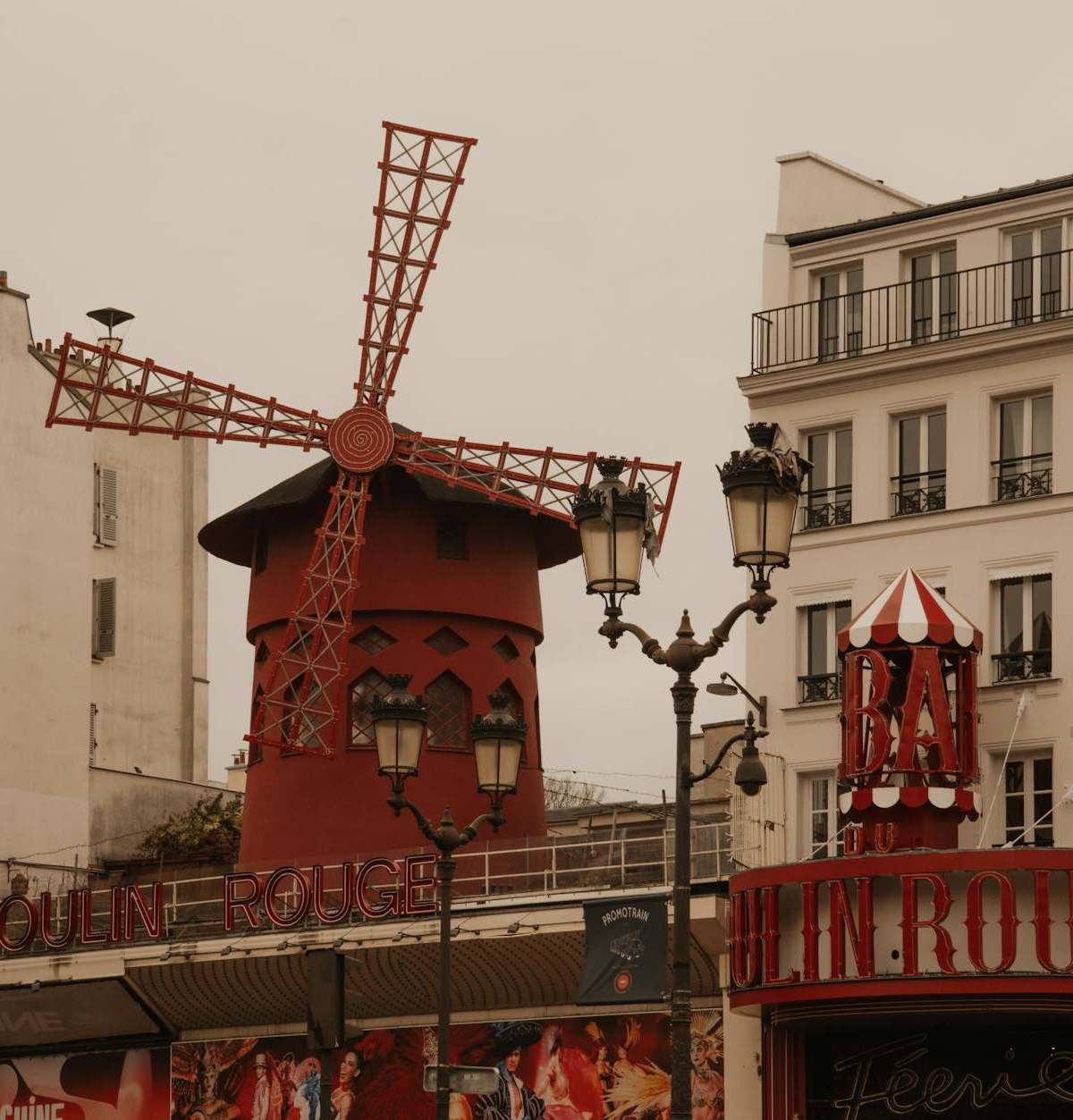 Capture of the historic Moulin Rouge in Montmartre, Paris, showcasing its famous red windmill.