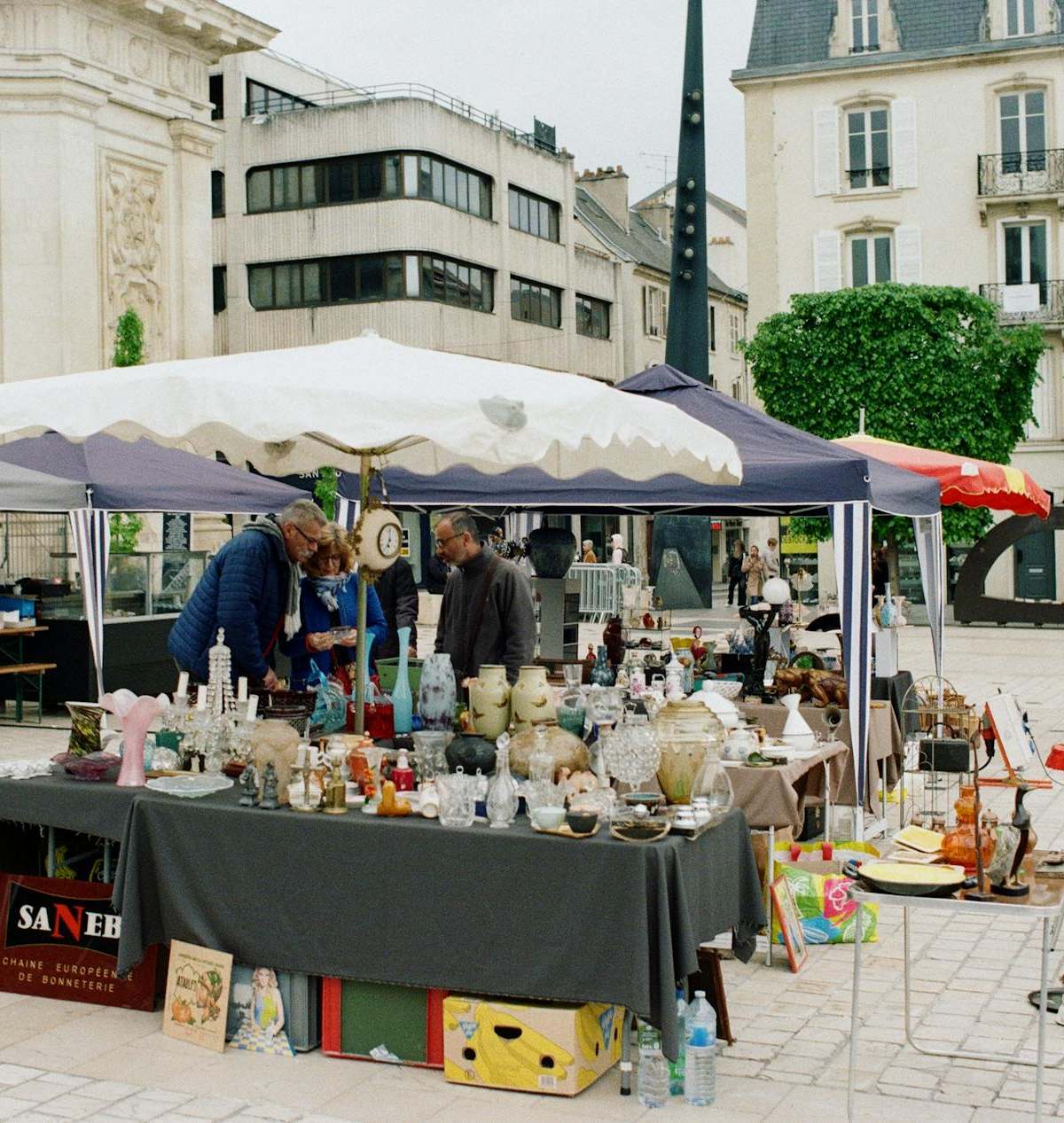 Explore vibrant market stalls in Nancy's town square, Grand Est, France.