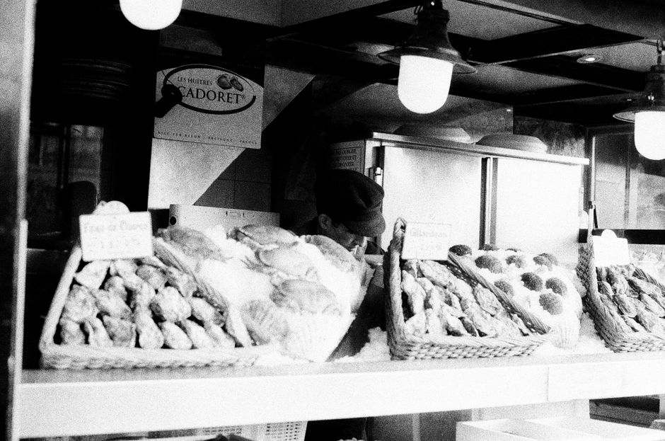 A nostalgic black and white image of a Parisian bakery stall.