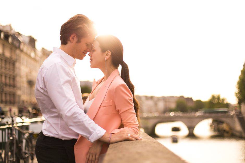 A couple beside the Seine at sunset