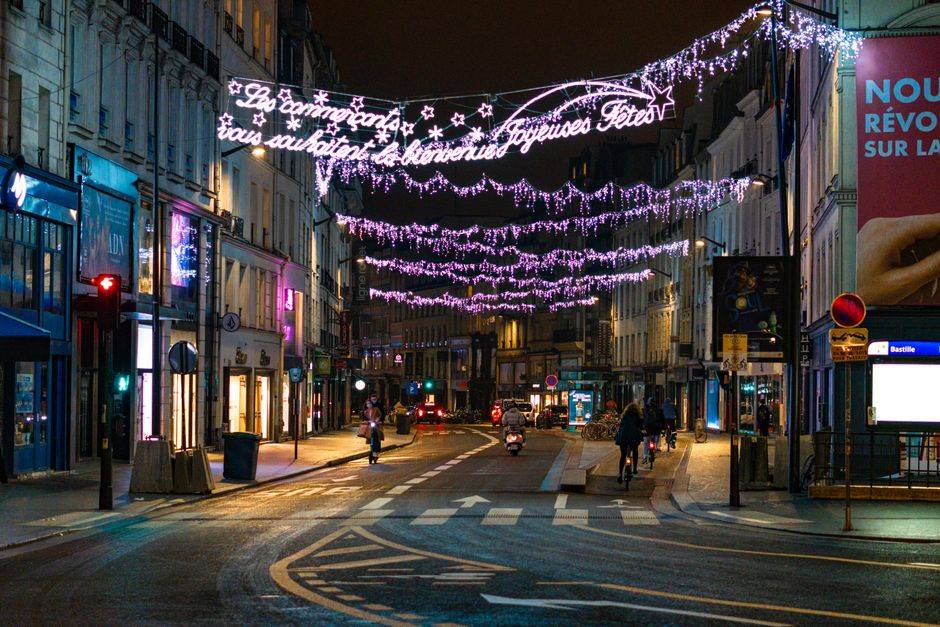 Christmas lights above a Paris shopping street