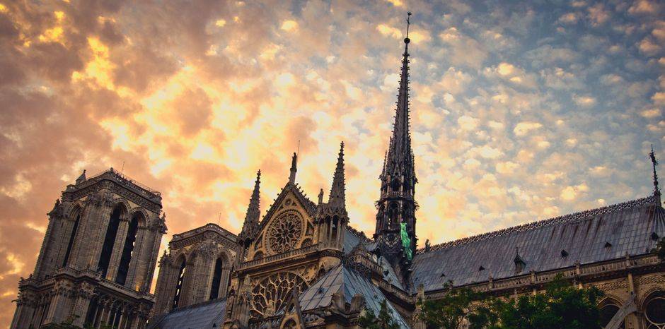 Notre-Dame and its spire beneath a colorful sky