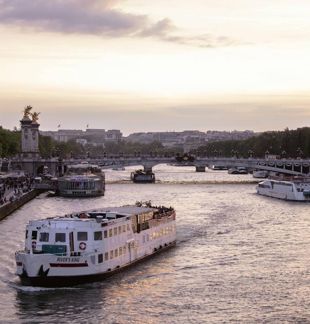 A boat on the Seine at sunset near Pont Alexandre III
