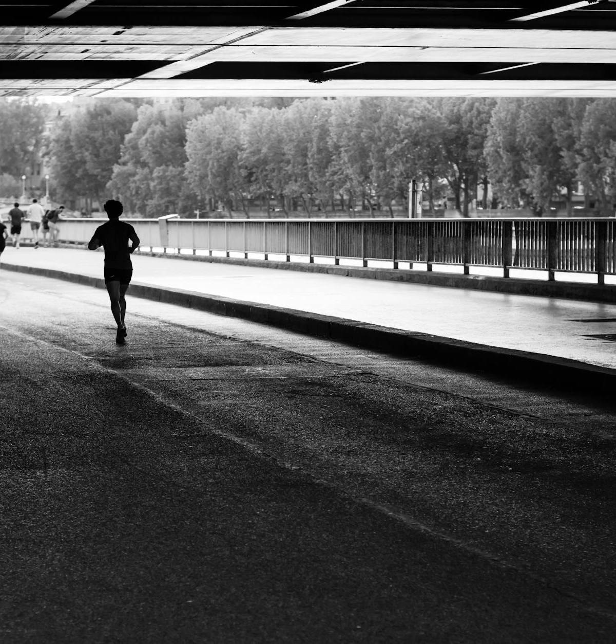 A runner beside the Seine, photographed in black and white
