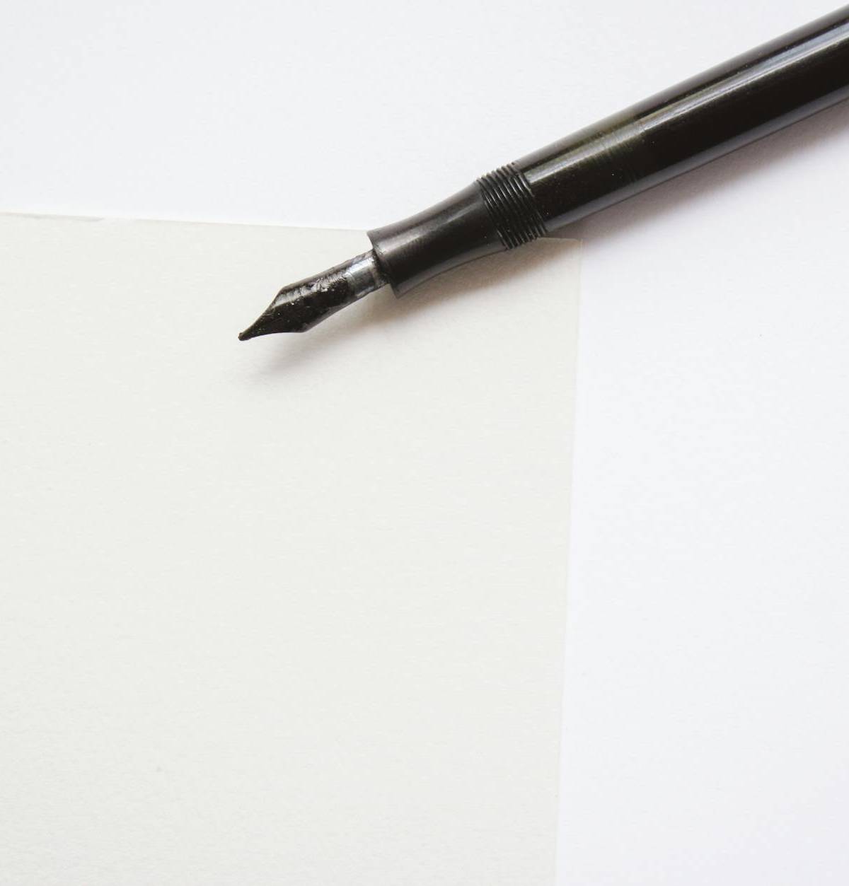 A fountain pen on white paper