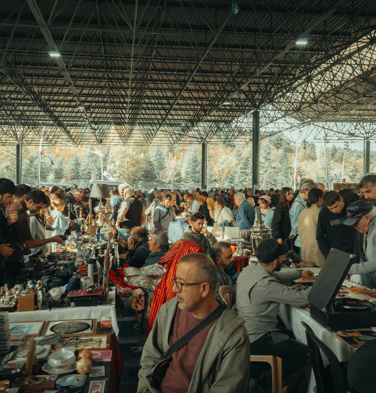 Shoppers beneath a flea-market roof