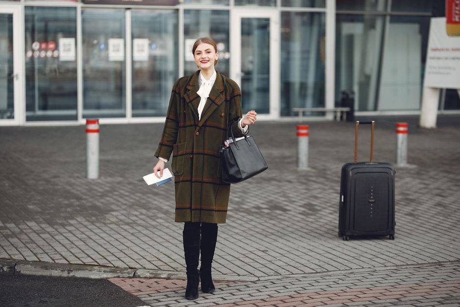 A traveler carrying a suitcase, illustrative photograph