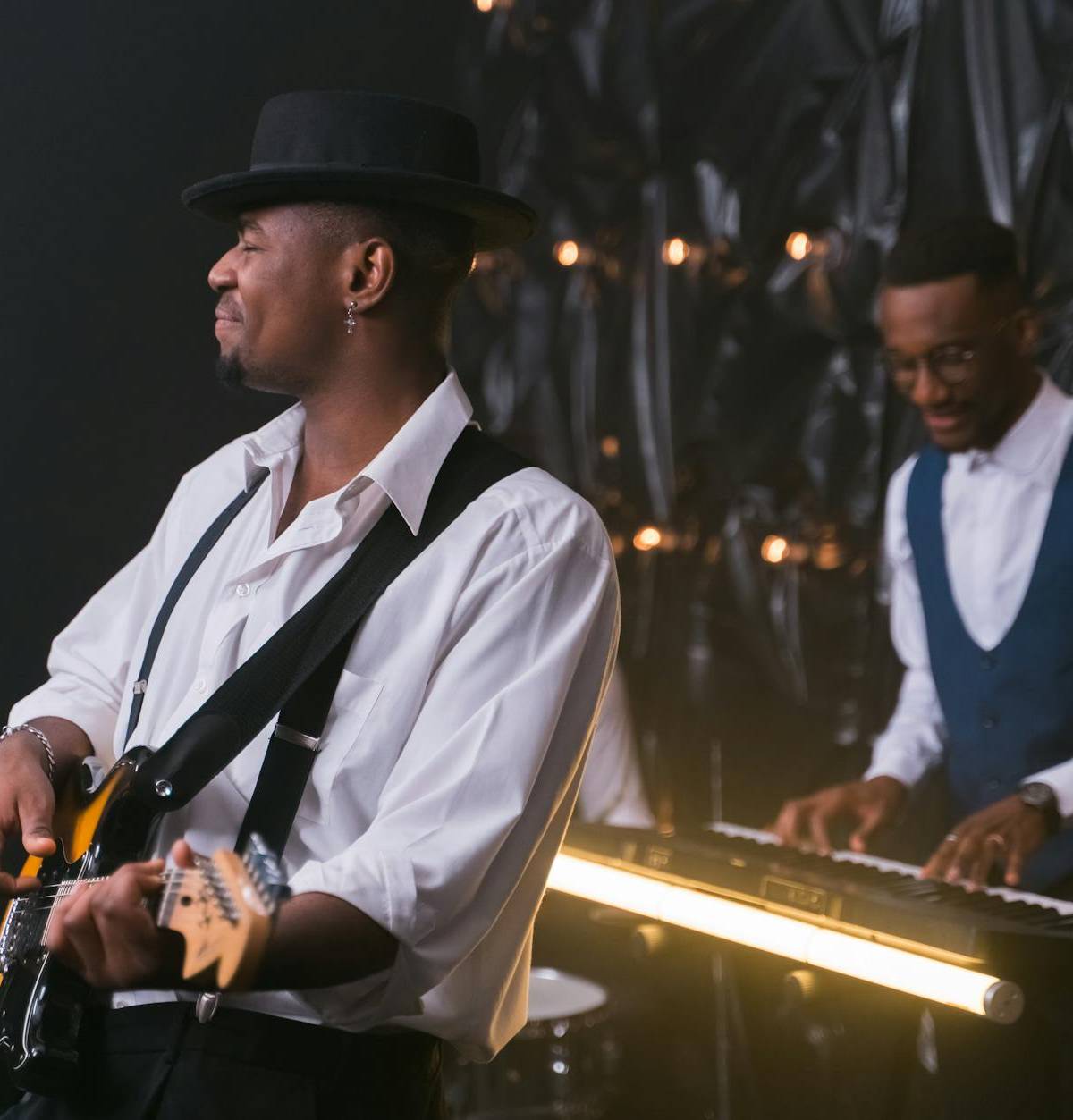 A guitarist performing with a jazz ensemble, illustrative photograph