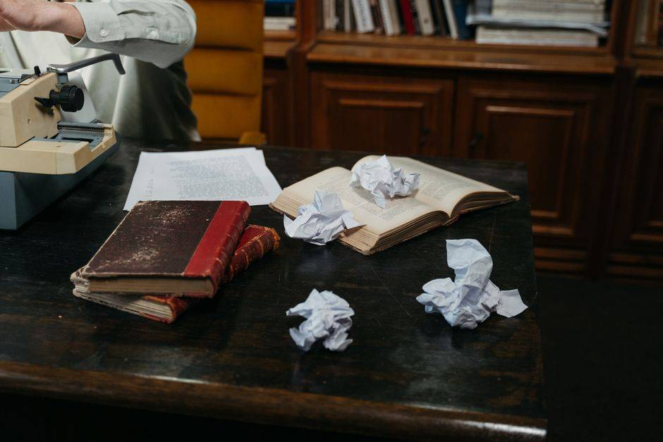 Books and papers on a writer’s desk, illustrative photograph